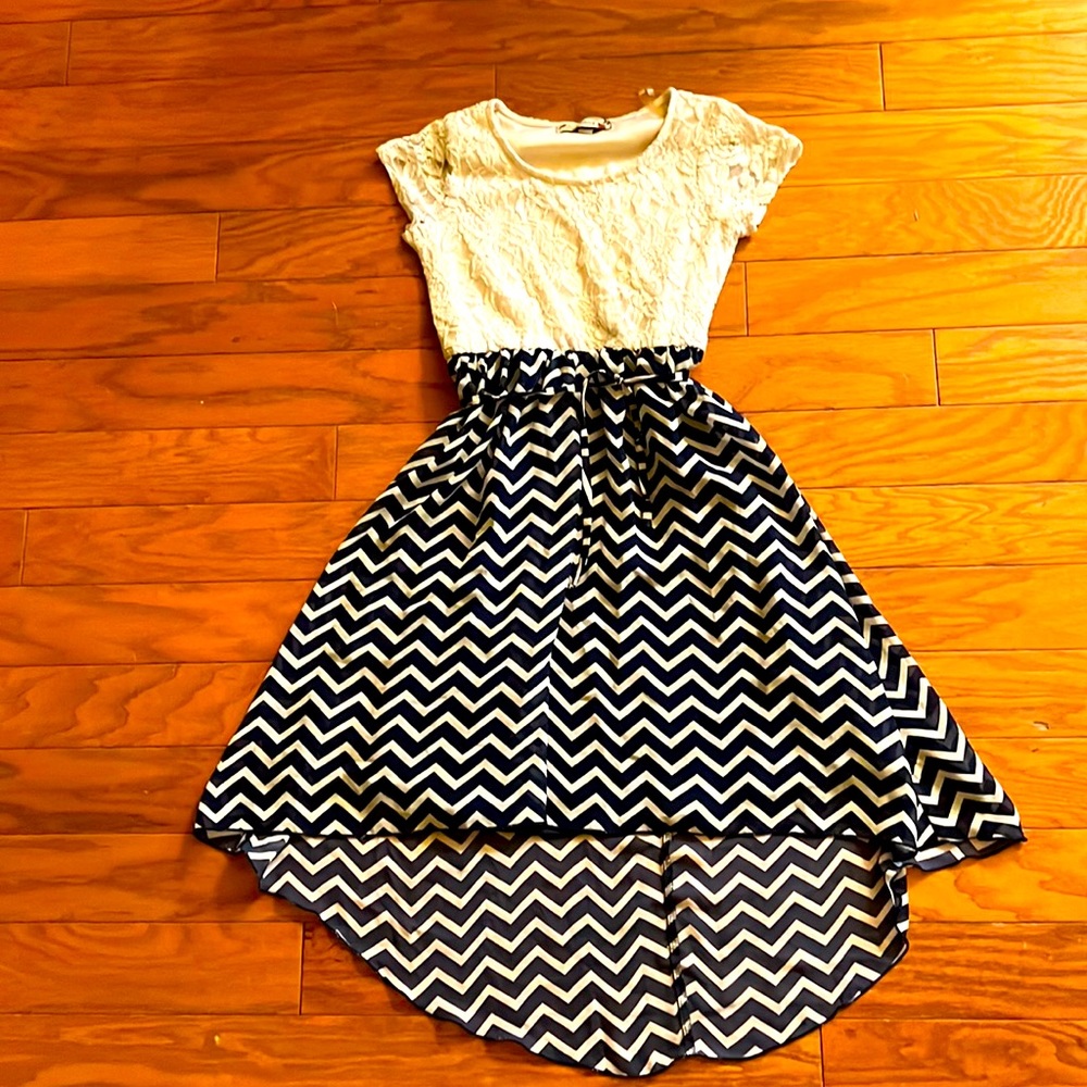 Kids dress with leaf/ flower design on top and zigzag stripes on the bottom.
